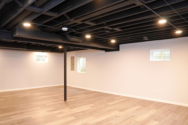 13636 Savanna Dr, Plainfield, IL 60544 - below grade area with light wood finished floors, healthy amount of natural light, baseboards, and electric panel