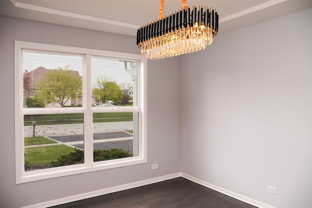 13636 Savanna Dr, Plainfield, IL 60544 - empty room featuring a chandelier, dark wood-style flooring, and baseboards