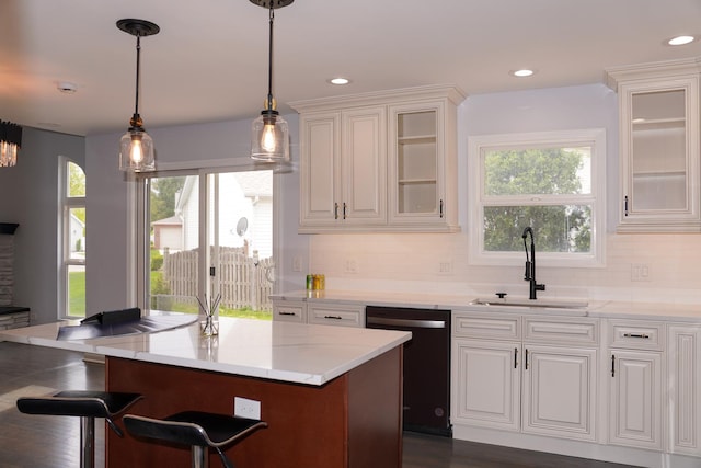 13636 Savanna Dr, Plainfield, IL 60544 - kitchen with a sink, dishwasher, white cabinets, decorative backsplash, and healthy amount of natural light