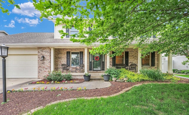 3408 Mill Creek Ct, Champaign, IL 61822 - view of front of home featuring covered porch, an attached garage, driveway, and brick siding