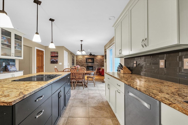 3408 Mill Creek Ct, Champaign, IL 61822 - kitchen featuring stainless steel dishwasher, black electric cooktop, backsplash, white cabinetry, and hanging light fixtures