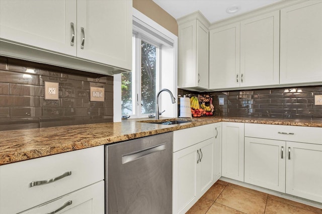 3408 Mill Creek Ct, Champaign, IL 61822 - kitchen with stainless steel dishwasher, a sink, decorative backsplash, light tile patterned floors, and white cabinets