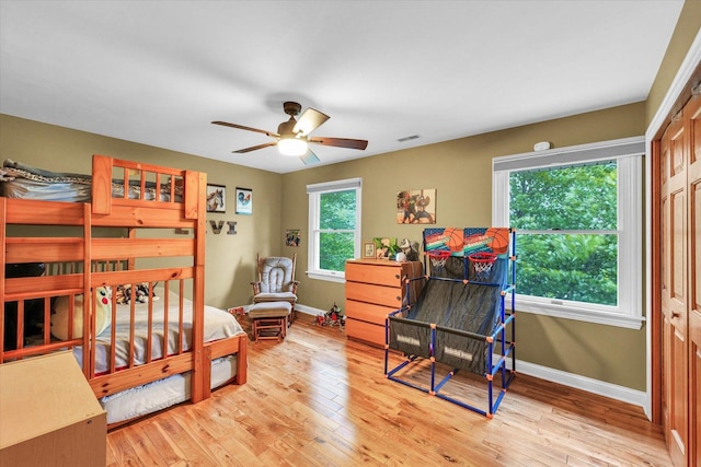 3408 Mill Creek Ct, Champaign, IL 61822 - bedroom with baseboards, light wood-type flooring, and ceiling fan