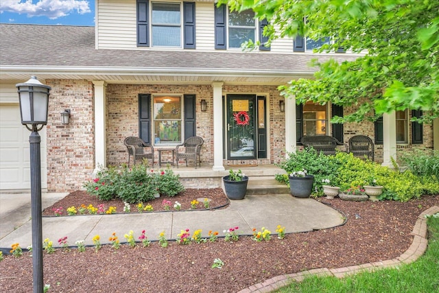 3408 Mill Creek Ct, Champaign, IL 61822 - property entrance featuring covered porch, brick siding, and roof with shingles