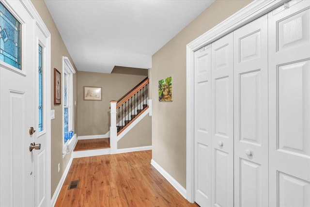 3408 Mill Creek Ct, Champaign, IL 61822 - entryway with light wood-style floors, baseboards, and stairs