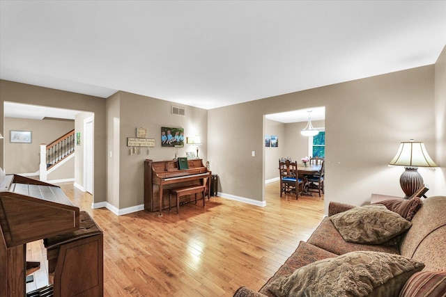 3408 Mill Creek Ct, Champaign, IL 61822 - living area featuring light wood finished floors, baseboards, and stairs