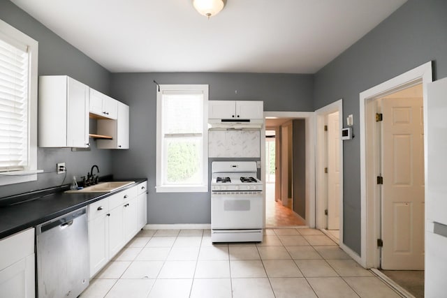 2940 W 38th St, Chicago, IL 60632 - kitchen with dishwasher, white gas range oven, a sink, dark countertops, and white cabinetry