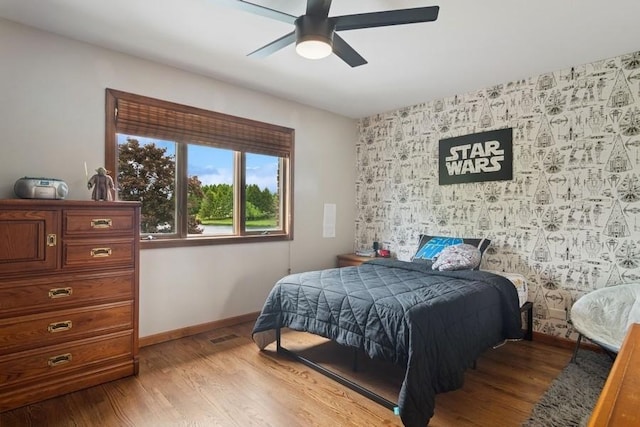 22902 W Lochanora Dr, Hawthorn Woods, IL 60047 - bedroom featuring an accent wall, wood finished floors, baseboards, and a ceiling fan