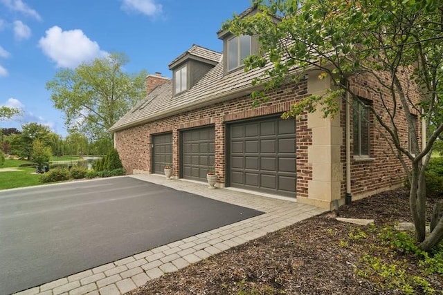 22902 W Lochanora Dr, Hawthorn Woods, IL 60047 - view of home's exterior featuring brick siding, driveway, and an attached garage