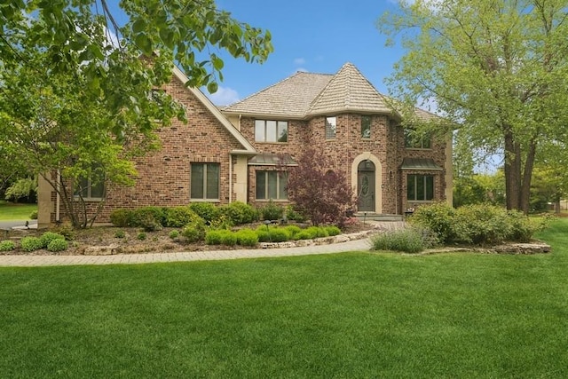 22902 W Lochanora Dr, Hawthorn Woods, IL 60047 - tudor home featuring a front lawn, brick siding, and a high end roof
