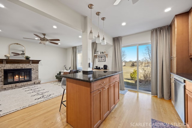 647 Glacier Trl, Roselle, IL 60172 - kitchen featuring ceiling fan, light wood finished floors, a glass covered fireplace, a breakfast bar area, and recessed lighting