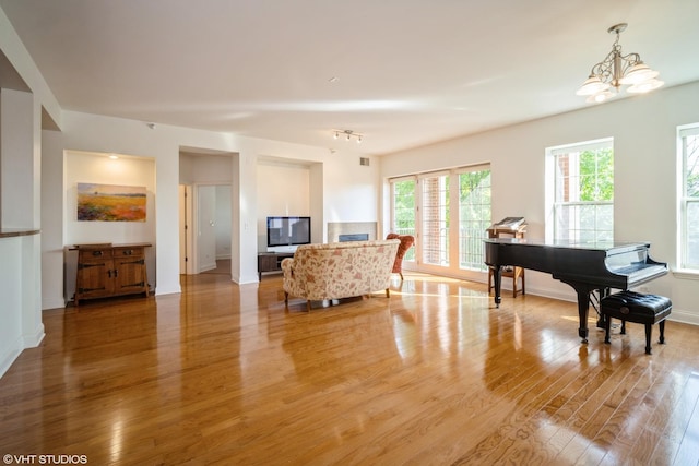 2700 Summit Dr Unit 307, Glenview, IL 60025 - living room featuring light wood finished floors, a chandelier, and baseboards
