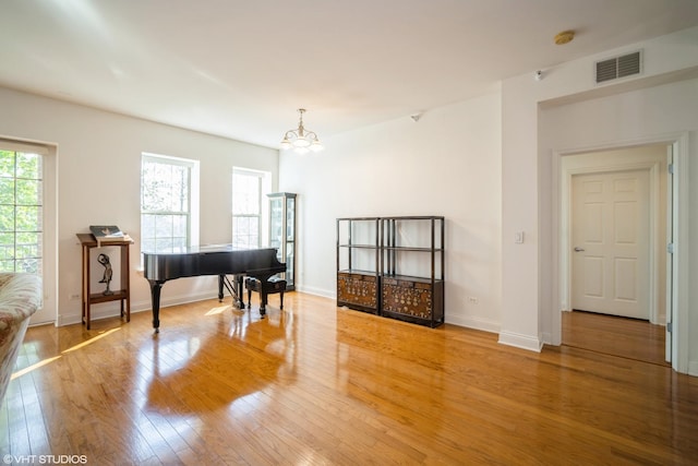 2700 Summit Dr Unit 307, Glenview, IL 60025 - sitting room featuring wood finished floors, a chandelier, and baseboards