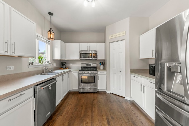 1876 Ione Ln, Aurora, IL 60503 - kitchen with appliances with stainless steel finishes, a sink, dark wood finished floors, white cabinets, and light countertops