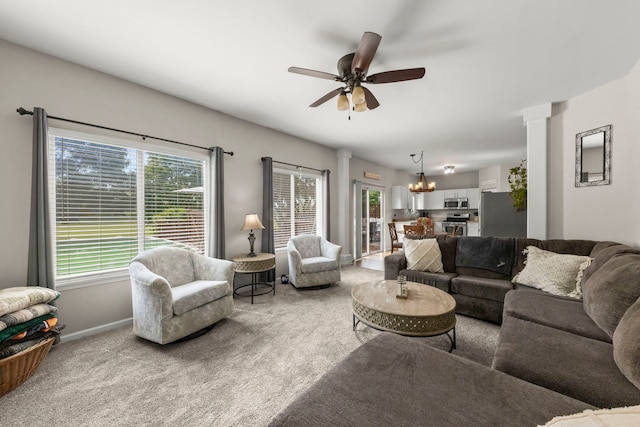 1876 Ione Ln, Aurora, IL 60503 - carpeted living area with a chandelier, a ceiling fan, ornate columns, and baseboards