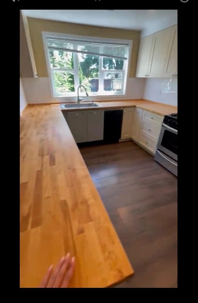 4044 Wesley Ter, Schiller Park, IL 60176 - kitchen with stainless steel range with gas stovetop, wood counters, a sink, white cabinetry, and dishwasher