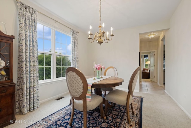 12433 Foxtail Ln, Huntley, IL 60142 - dining area with light colored carpet, a chandelier, healthy amount of natural light, and baseboards
