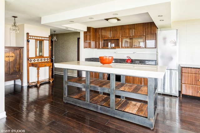 5455 N Sheridan Rd Unit 901, Chicago, IL 60640 - kitchen with brown cabinets, freestanding refrigerator, dark wood-style flooring, light countertops, and modern cabinets