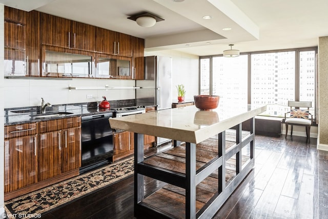 5455 N Sheridan Rd Unit 901, Chicago, IL 60640 - kitchen with black dishwasher, a sink, dark wood-style floors, dark stone countertops, and brown cabinetry
