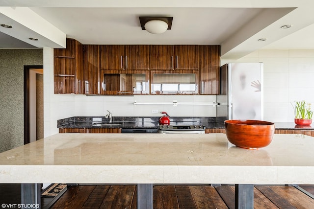 5455 N Sheridan Rd Unit 901, Chicago, IL 60640 - kitchen with a sink, stainless steel appliances, dark stone counters, decorative backsplash, and modern cabinets