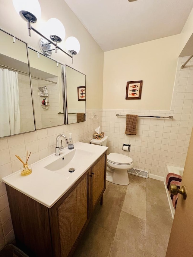 270 W Margaret Fuller Rd, Oregon, IL 61061 - bathroom with tile walls, vanity, toilet, tile patterned floors, and shower / tub combo