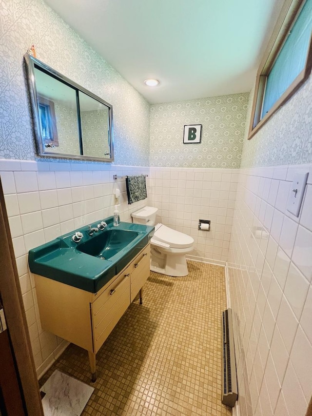 270 W Margaret Fuller Rd, Oregon, IL 61061 - bathroom featuring wallpapered walls, wainscoting, tile walls, toilet, and vanity