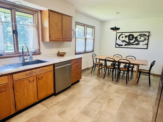 270 W Margaret Fuller Rd, Oregon, IL 61061 - kitchen featuring stainless steel dishwasher, a sink, light countertops, brown cabinetry, and pendant lighting