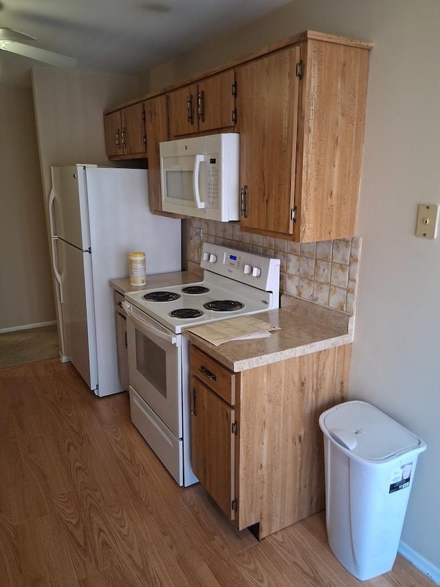 1702 Mill St Unit 502, Des Plaines, IL 60016 - kitchen featuring white appliances, decorative backsplash, light wood finished floors, light countertops, and brown cabinetry