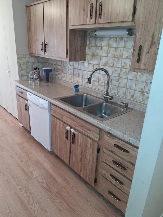 1702 Mill St Unit 502, Des Plaines, IL 60016 - kitchen featuring dishwasher, a sink, backsplash, light countertops, and light wood-style flooring