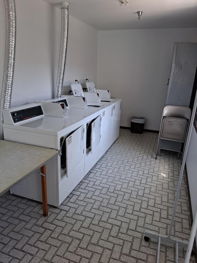 1702 Mill St Unit 502, Des Plaines, IL 60016 - shared laundry room with washer and dryer and brick patterned flooring