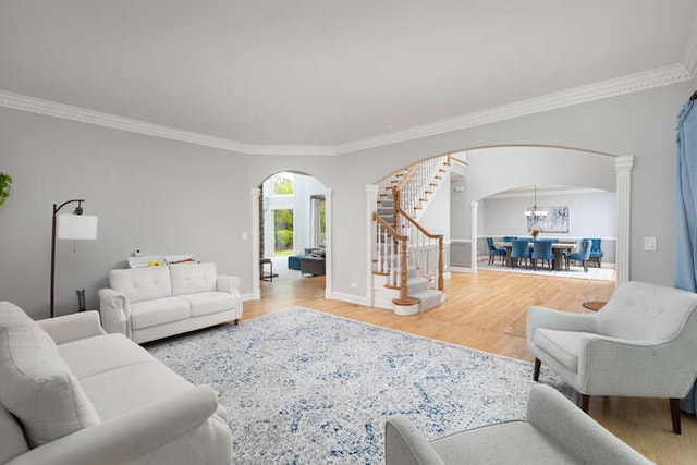 3211 Treyburn Rd, Naperville, IL 60564 - living room with arched walkways, stairway, ornamental molding, wood finished floors, and baseboards