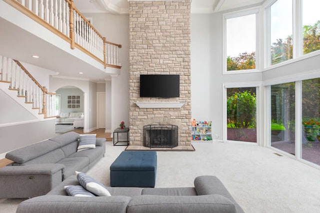 3211 Treyburn Rd, Naperville, IL 60564 - living area featuring a high ceiling, stairway, a fireplace, carpet, and arched walkways