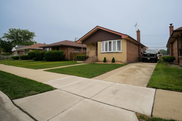3743 E 112th St, Chicago, IL 60617 - view of front of house featuring brick siding, driveway, a front yard, and a chimney