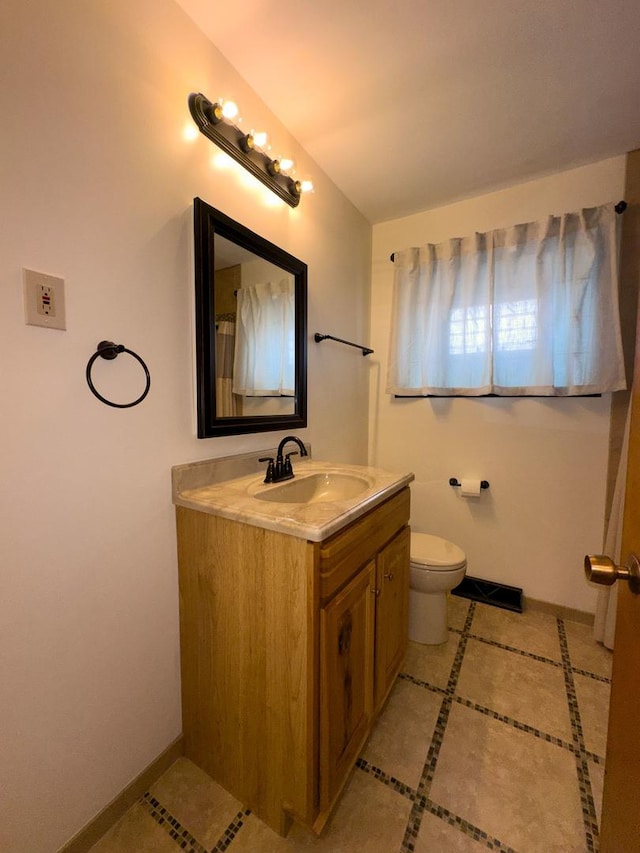 3743 E 112th St, Chicago, IL 60617 - full bathroom featuring vanity, toilet, tile patterned floors, and baseboards