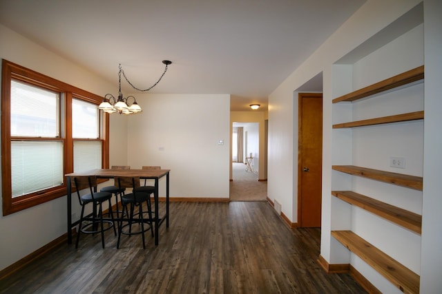 3743 E 112th St, Chicago, IL 60617 - dining room featuring baseboards, a chandelier, and dark wood-style flooring