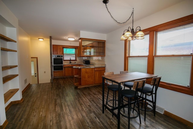 3743 E 112th St, Chicago, IL 60617 - dining space with dark wood finished floors, a chandelier, and baseboards