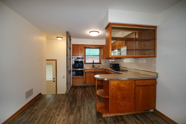 3743 E 112th St, Chicago, IL 60617 - kitchen featuring a sink, black appliances, brown cabinets, and tasteful backsplash