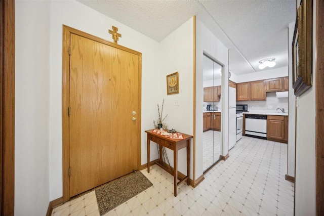7414 W Irving Park Rd Unit 206, Norridge, IL 60706 - foyer entrance featuring a textured ceiling, baseboards, and light floors