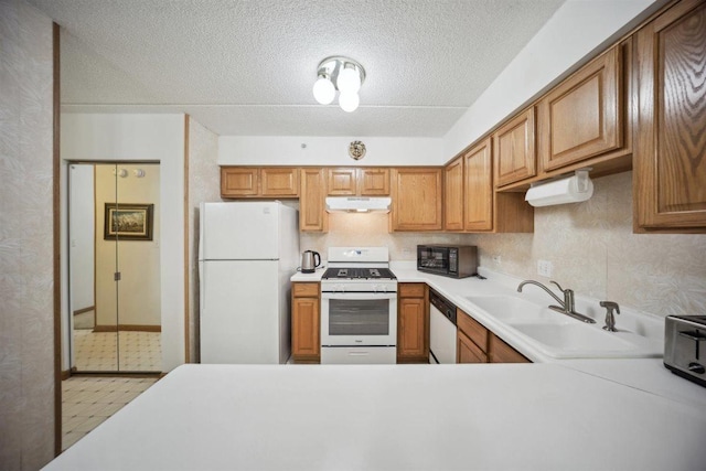 7414 W Irving Park Rd Unit 206, Norridge, IL 60706 - kitchen with white appliances, under cabinet range hood, light countertops, a sink, and brown cabinets