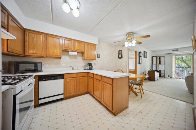 7414 W Irving Park Rd Unit 206, Norridge, IL 60706 - kitchen with white appliances, a peninsula, light floors, light countertops, and a textured ceiling