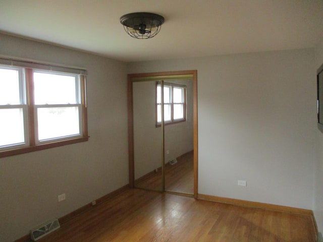 7804 Newland Ave, Burbank, IL 60459 - unfurnished bedroom featuring a closet and light wood-style flooring