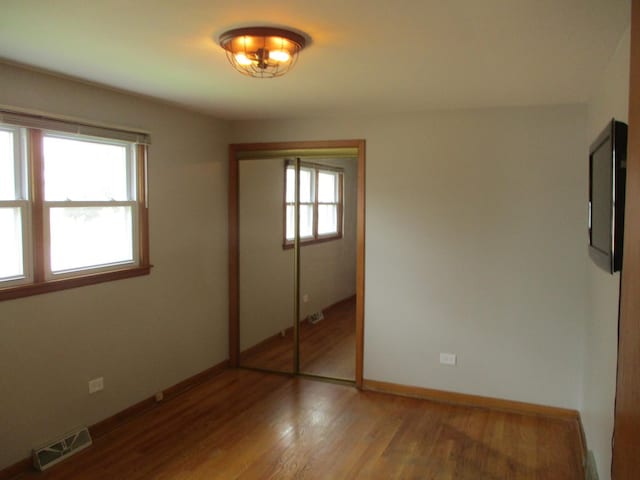 7804 Newland Ave, Burbank, IL 60459 - unfurnished bedroom with light wood-style floors and a closet
