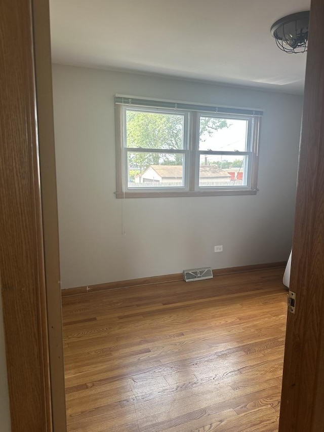 7804 Newland Ave, Burbank, IL 60459 - unfurnished room featuring healthy amount of natural light and wood finished floors
