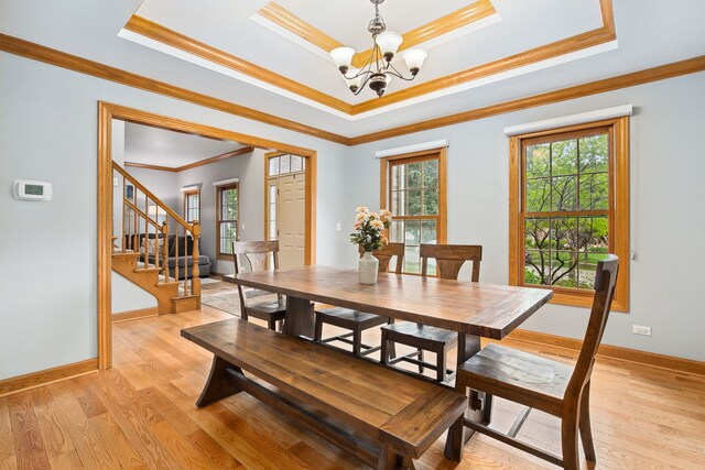 1284 N Jack Pine Ct, Palatine, IL 60067 - dining room featuring a chandelier, a raised ceiling, crown molding, stairway, and light wood finished floors