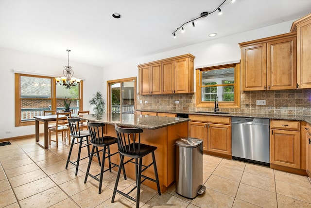 1284 N Jack Pine Ct, Palatine, IL 60067 - kitchen with stainless steel dishwasher, a sink, backsplash, a kitchen bar, and a kitchen island