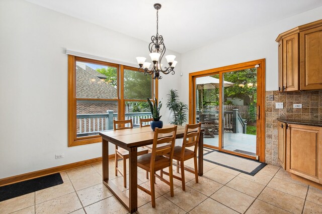 1284 N Jack Pine Ct, Palatine, IL 60067 - dining area with healthy amount of natural light, a chandelier, baseboards, and light tile patterned floors