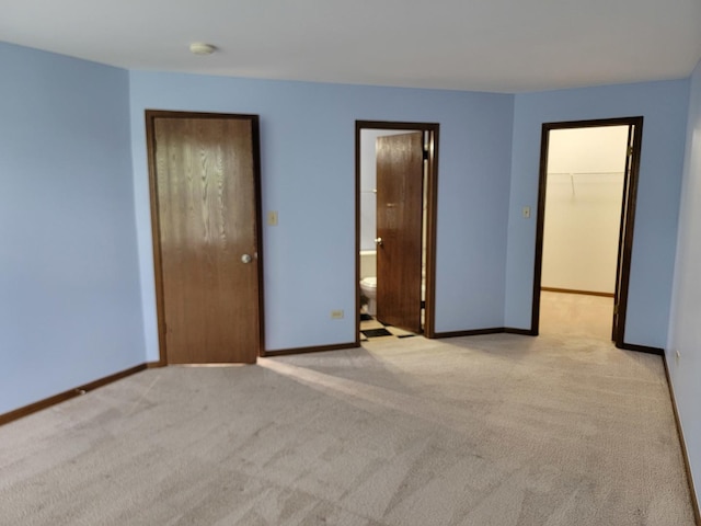1744 Eastwood Ct Unit 9, Schaumburg, IL 60195 - unfurnished bedroom with light colored carpet, baseboards, a spacious closet, and a closet