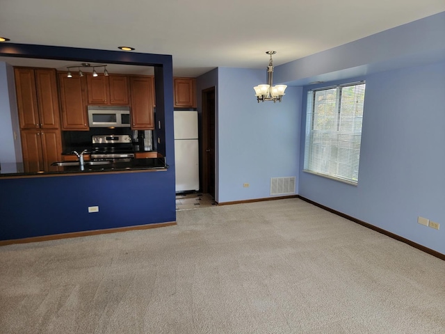 1744 Eastwood Ct Unit 9, Schaumburg, IL 60195 - kitchen with white appliances, dark countertops, light colored carpet, and a chandelier