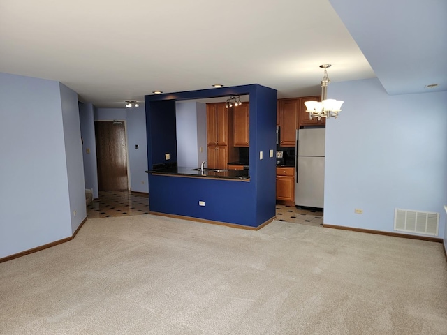 1744 Eastwood Ct Unit 9, Schaumburg, IL 60195 - kitchen with freestanding refrigerator, baseboards, dark countertops, and a chandelier