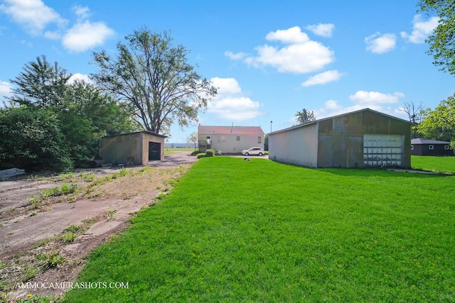 2N562 Atlantic Dr, West Chicago, IL 60185 - view of green lawn featuring an outbuilding and a garage